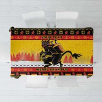 Yellow Christmas tablecloth with Krampus graphic, chain border, and “MERRY KRAMPUS” text