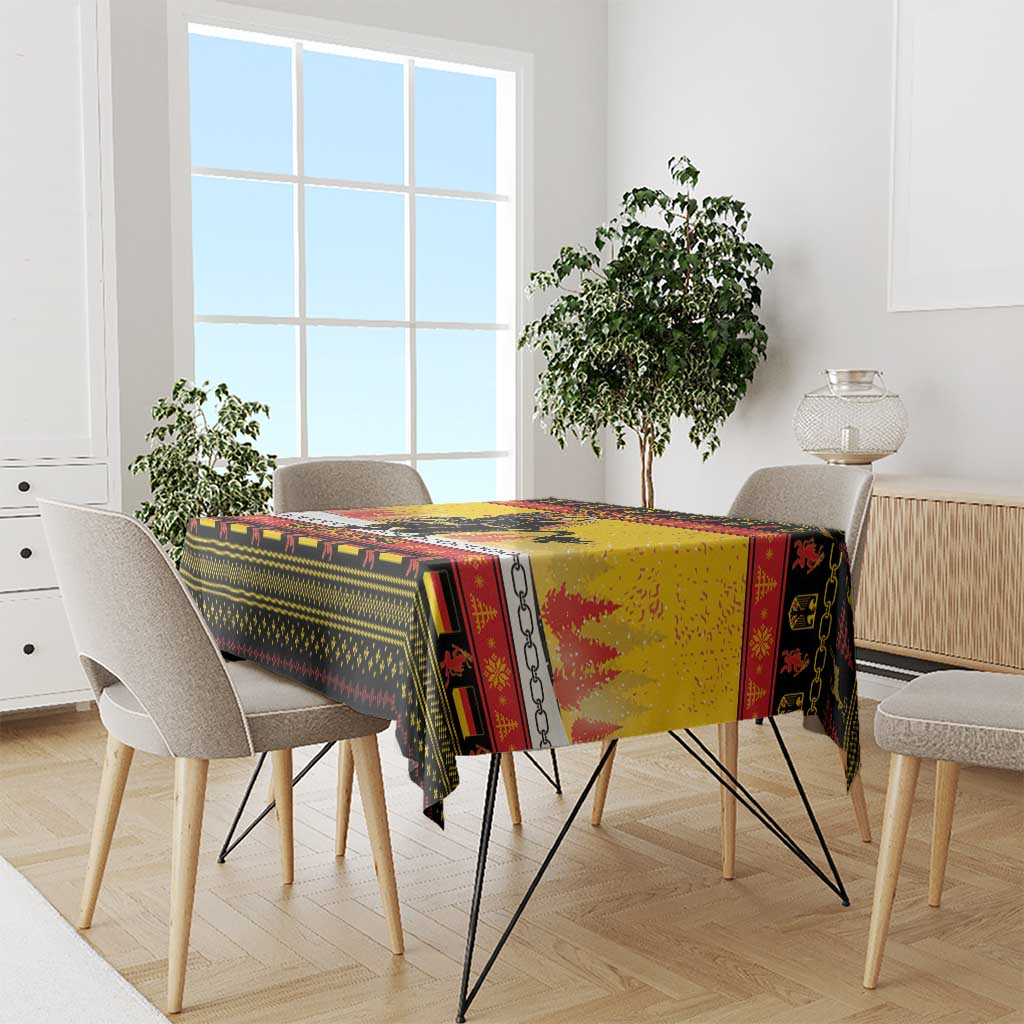 Yellow Christmas tablecloth with Krampus and chain pattern across tabletop