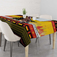 Yellow Christmas tablecloth draped over dining table with Krampus and chain motifs