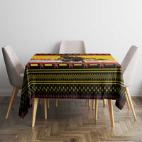 Yellow Christmas tablecloth on dining table with Krampus, chains, and “MERRY KRAMPUS”