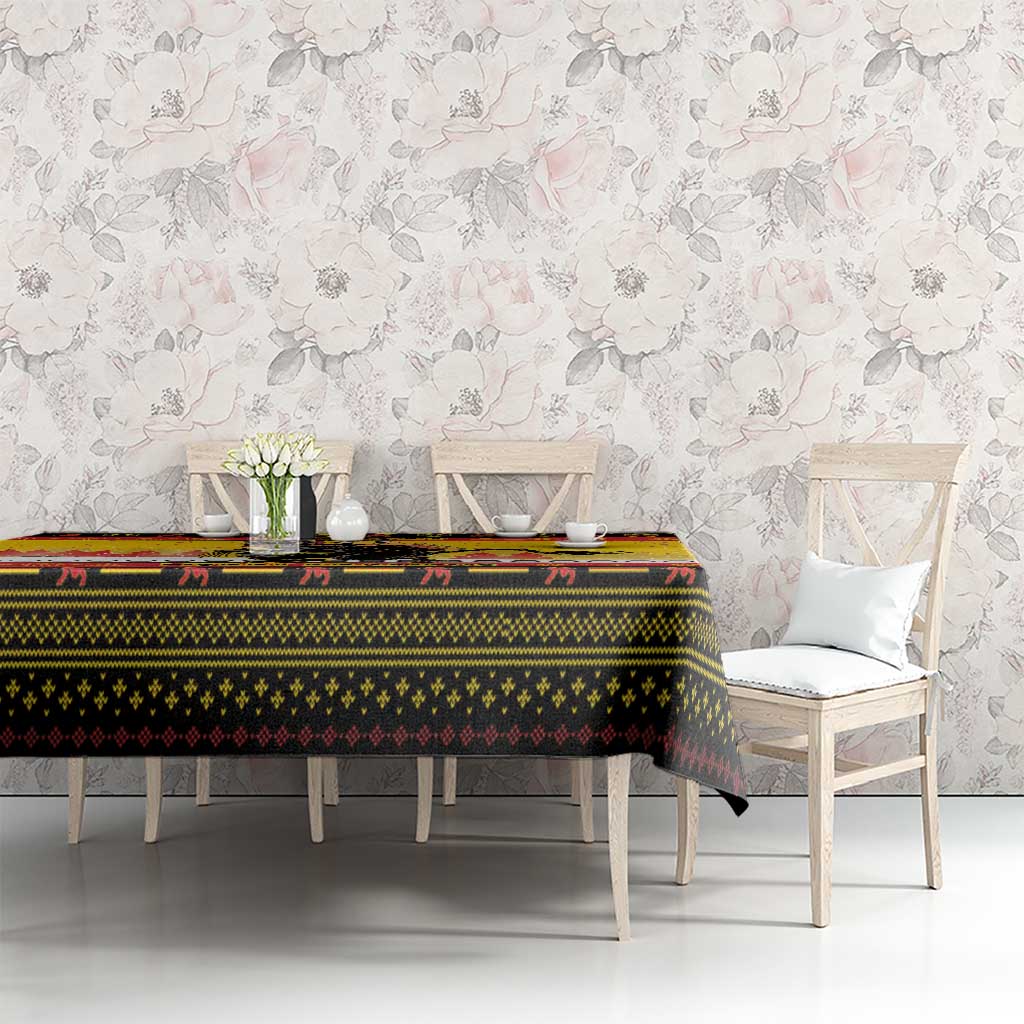 Yellow Krampus Christmas tablecloth on long table with patterned border and chain details