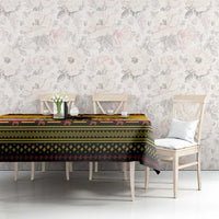 Yellow Krampus Christmas tablecloth on long table with patterned border and chain details