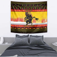 Yellow holiday wall tapestry with dark Krampus figure, pine tree band, and red trim.