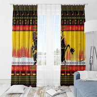 Yellow Christmas window curtain pair with white sheer panel behind, Krampus graphic visible