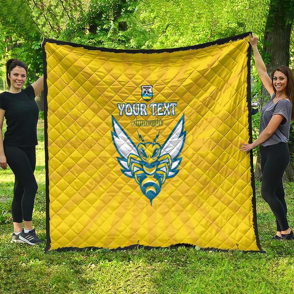 Yellow quilted football blanket with Rwanda emblem and blue crest, draped outdoors