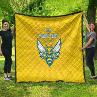Yellow quilted football blanket with Rwanda emblem and blue crest, draped outdoors