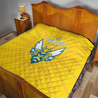 Yellow quilted football blanket with Rwanda emblem and blue crest on bed