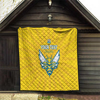 Yellow quilted football blanket with Rwanda emblem and blue crest, hanging on wall