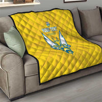 Yellow quilted football blanket with Rwanda emblem and blue crest on sofa
