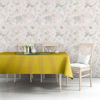 Yellow tablecloth with blue crest design on dining table in room setting