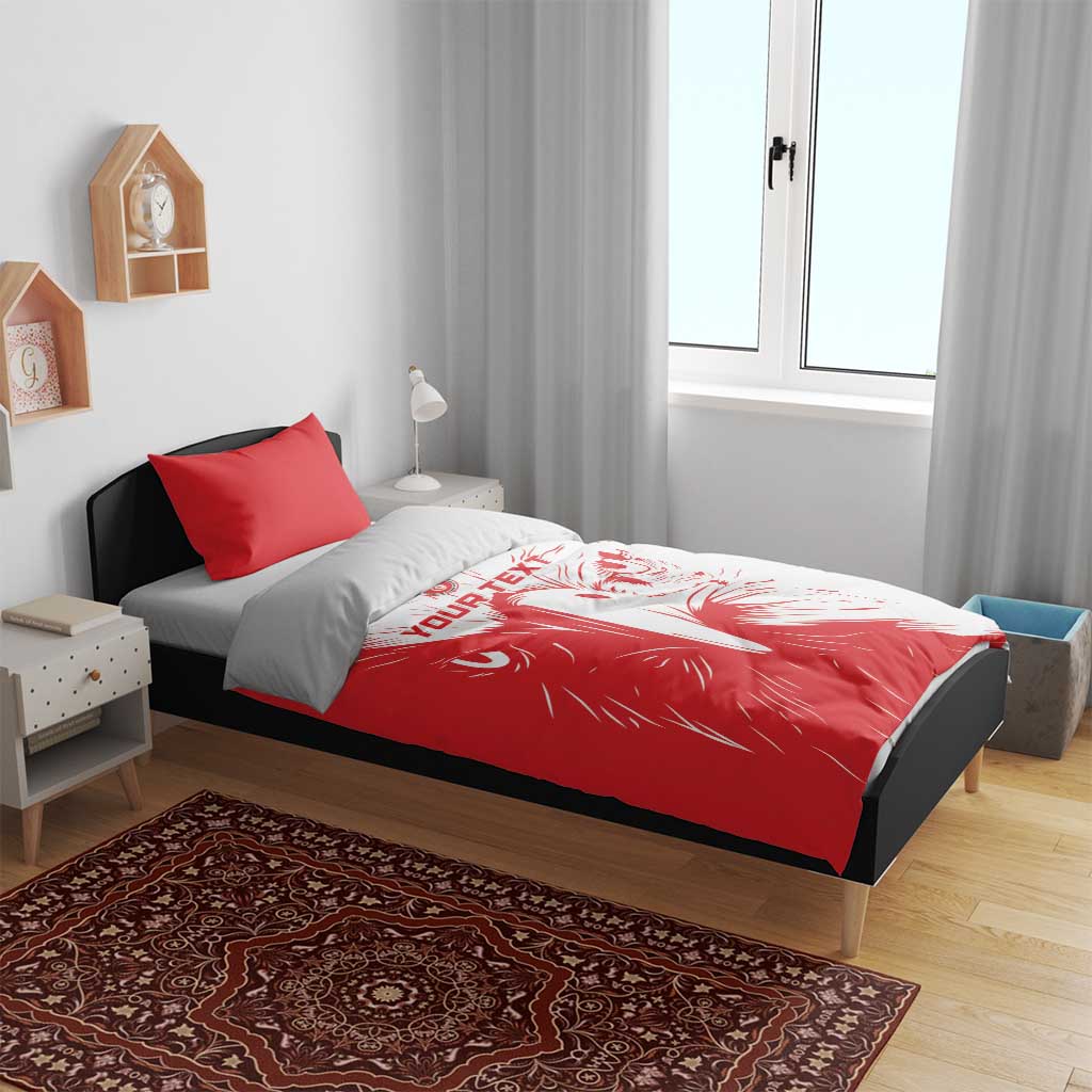 Red and white duvet with lion print and two red pillowcases on bed