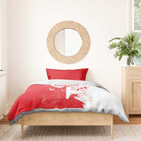 Red and white duvet with lion graphic and one red pillowcase on bed