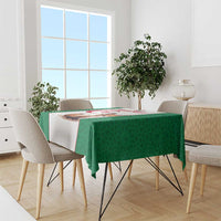 Green football tablecloth draped over a dining table with patterned sides and central print