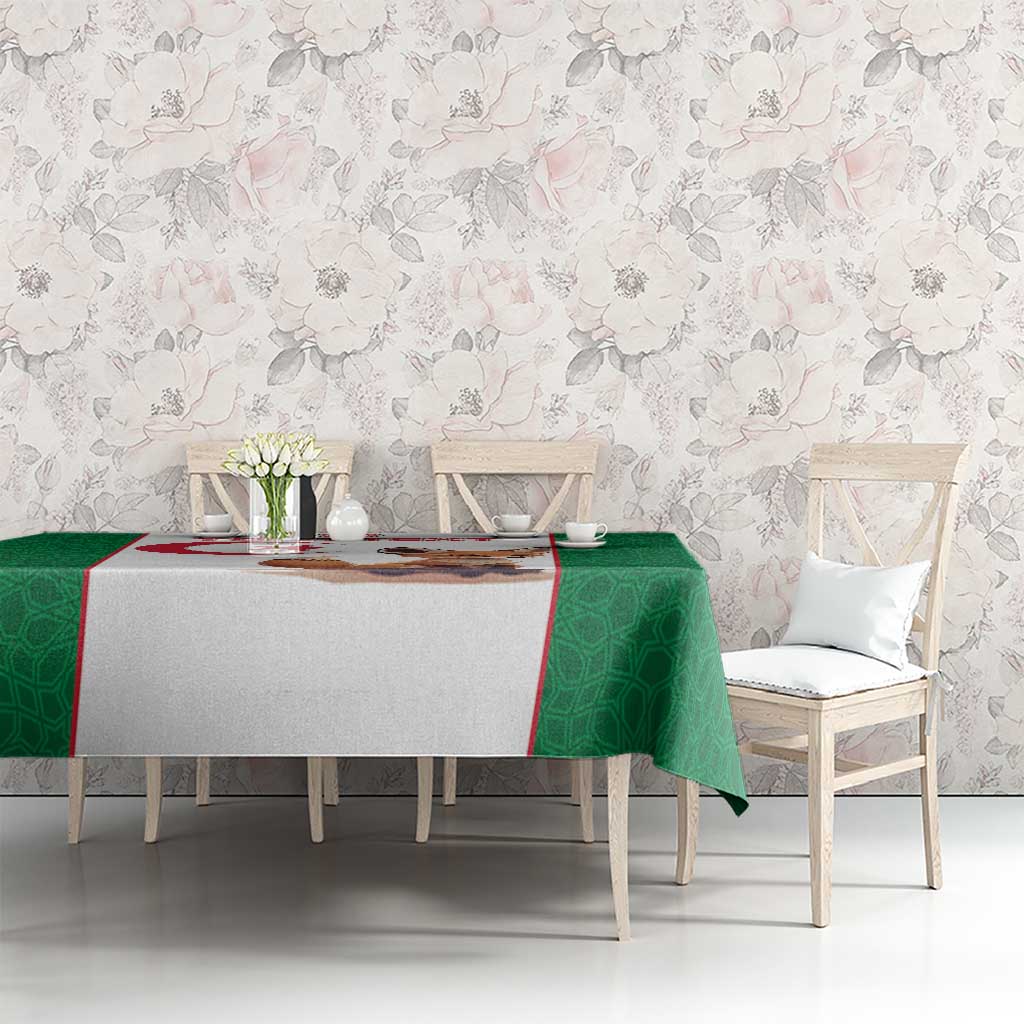 Green football tablecloth on a table with patterned sides and a central fox and flag print