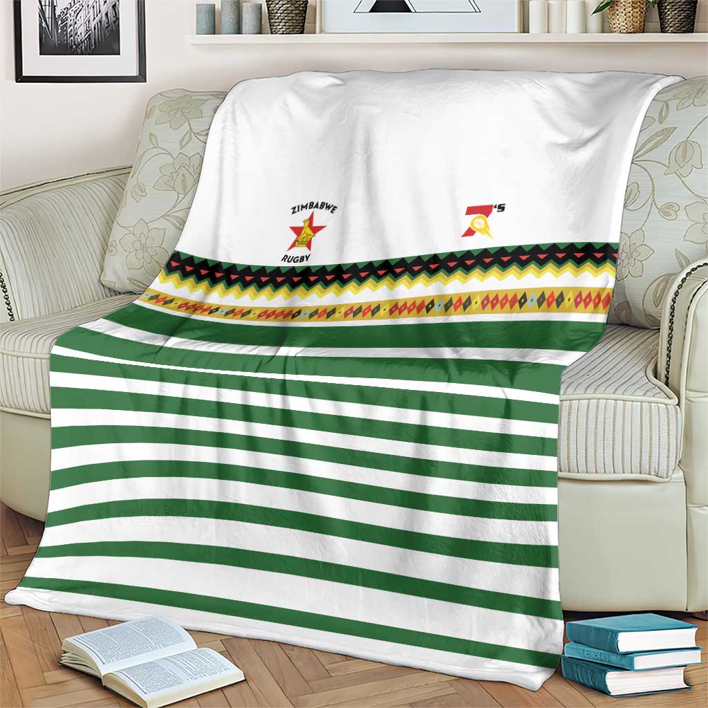 White and green striped rugby blanket with multicolor patterned band and team crests
