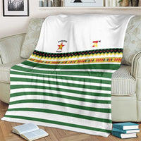 White and green striped rugby blanket with multicolor patterned band and team crests