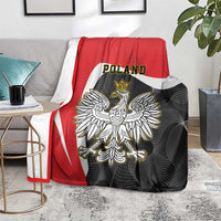 Crowned eagle print red-and-black blanket draped over couch with Poland text