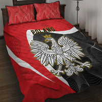 Red quilt bed set with crowned eagle centered over black patterned panel and white stripe