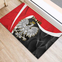 Red rubber doormat close-up with Poland crowned eagle on black background