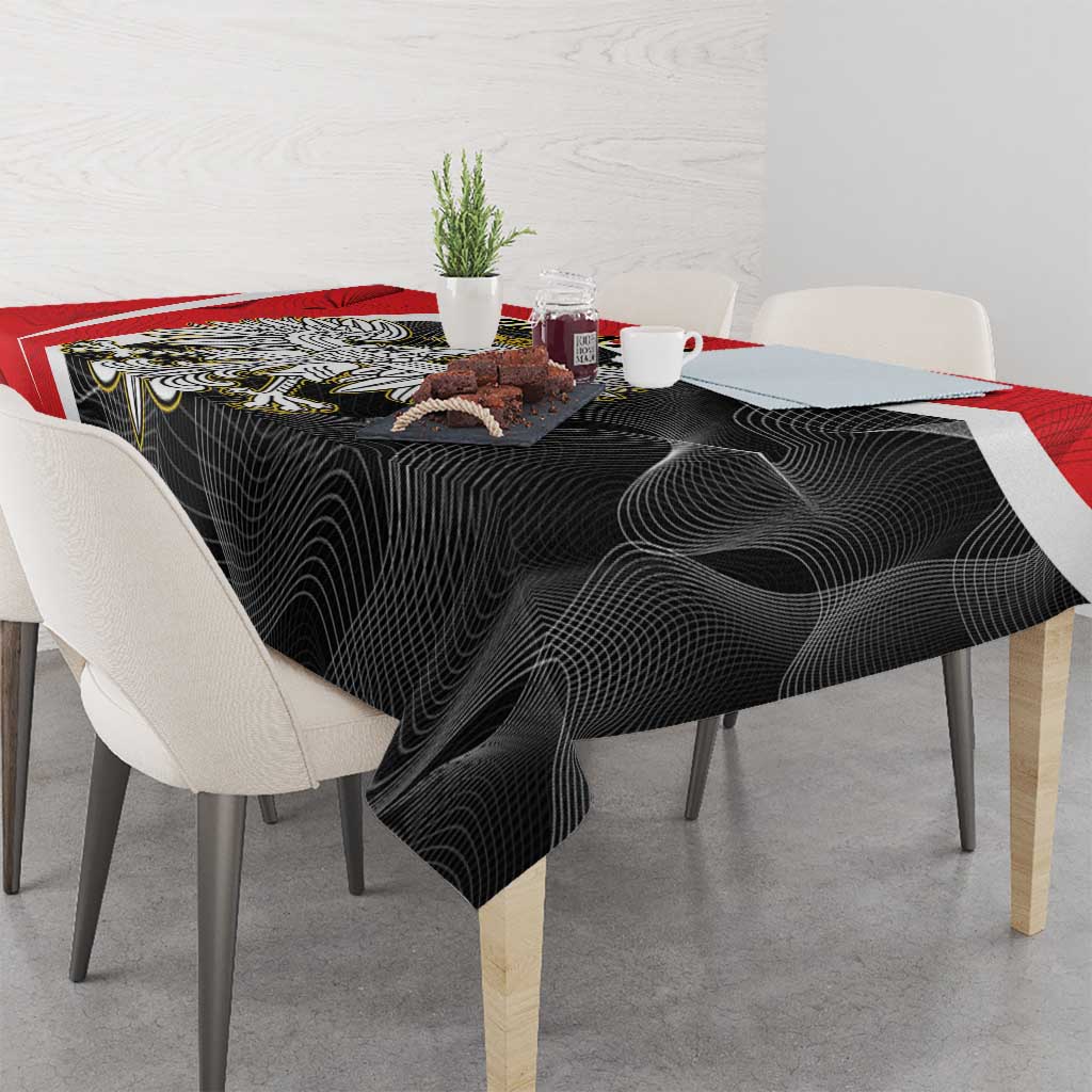 Black swirl tablecloth with red border on dining table with tableware
