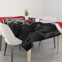 Black swirl tablecloth with red border on dining table with tableware