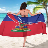 Haitian flag sarong draped over shoulders, red-and-blue with 'HAITI' print and emblem