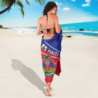 Haitian flag sarong worn as a beach wrap, red bottom, blue top with 'HAITI' text