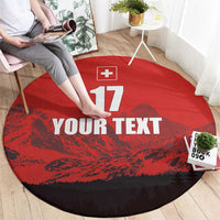 Red round football rug with Swiss cross, 17, and YOUR TEXT print, angled view.