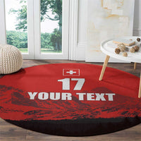 Red round football rug with Swiss cross, 17, and YOUR TEXT print, dark border.