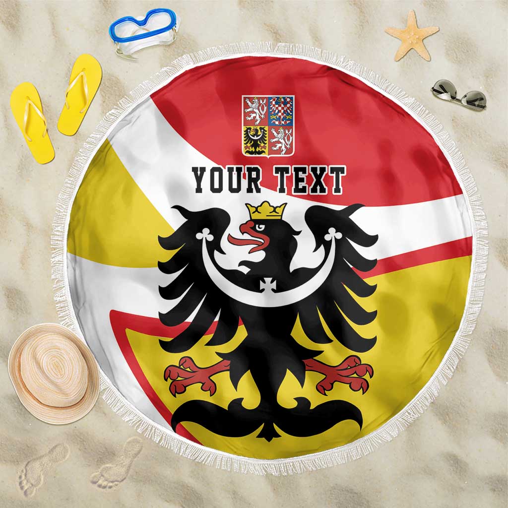 Personalized beach blanket with fringe, red/white/yellow stripes and black eagle crest, 'YOUR TEXT' centered.