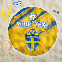 Yellow round beach blanket with blue crest and "YOUR TEXT", white fringe edge.