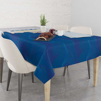 Blue tablecloth with coat of arms emblem on corner, spread across rectangular table