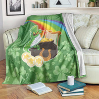 Green throw blanket with rainbow band, harp, pot of gold and clover pattern