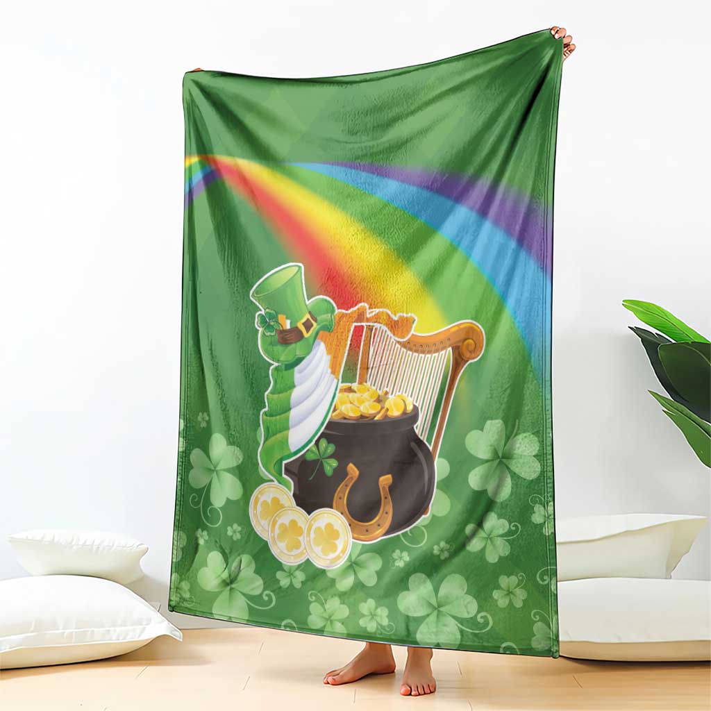 Green throw blanket draped with harp, pot of gold, rainbow stripe and clover