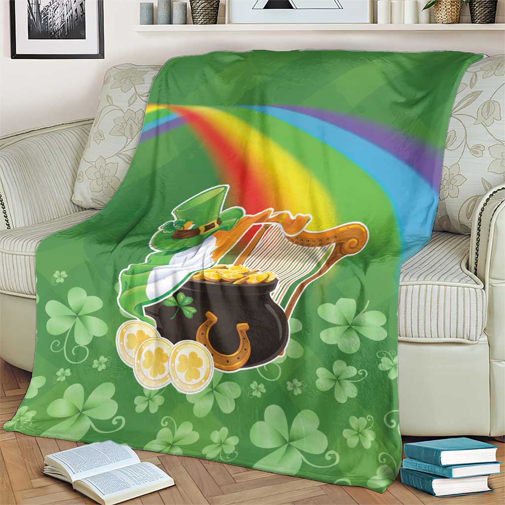 Green throw blanket with harp, pot of gold, rainbow stripe and clover motifs