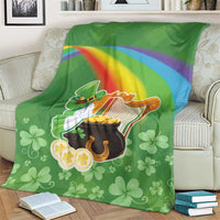 Green throw blanket with harp, pot of gold, rainbow stripe and clover motifs