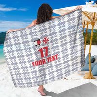 Custom sarong wrap in white and gray with geometric pattern, red logo, number 11 and text