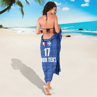 Blue football-style sarong with geometric pattern, number 17 and 'UR TEXT', soccer crest.