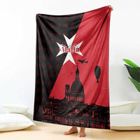 Red and black throw blanket draped with white star, Malta text, and dome skyline