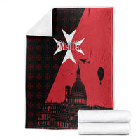 Folded red and black Malta throw blanket with white star and dome city skyline print