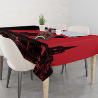 Red and black printed tablecloth with skyline pattern, laid across tabletop