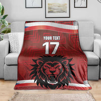 Red custom football blanket on sofa, lion head, 'YOUR TEXT' and number 17