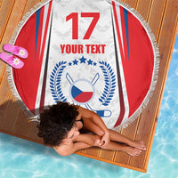 Round beach blanket with hockey badge graphic and red/blue/white flag stripes, fringed