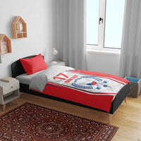 Red comforter bedding on a bed with Czech-style crest, “17” and “YOUR TEXT,” two red pillows