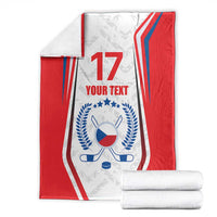 Folded red and white hockey blanket with blue flag emblem, number 17, and 'YOUR TEXT'.