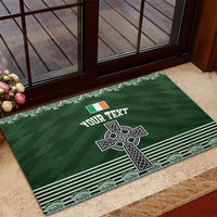 Green rubber doormat featuring Celtic cross and shamrock knot, striped edge and corner motifs