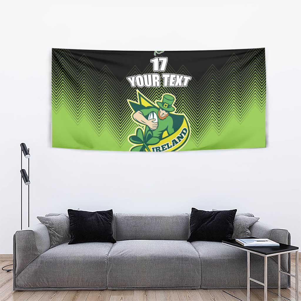Green and black rugby tapestry, zigzag pattern, leprechaun mascot holding clover, '17' 'YOUR TEXT' 'IRELAND'.