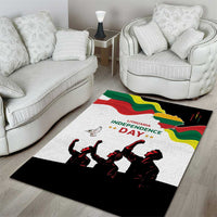 White area rug with red-green-yellow map, Independence Day lettering, and black dancer silhouettes