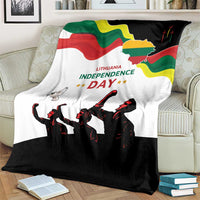 Independence Day blanket on couch, white top with green, yellow and red flag and black silhouettes