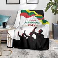 Independence Day blanket on gray sofa, flag crest graphic, text and marching silhouettes